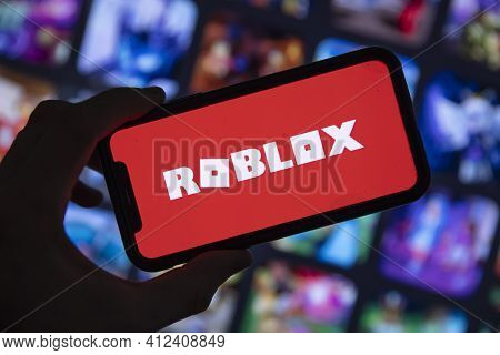 London, Uk - March 2021: Person Holding A Smartphone With Roblox Game Logo