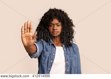 Serious Black Woman Showing Her Palm, Stop Gesture