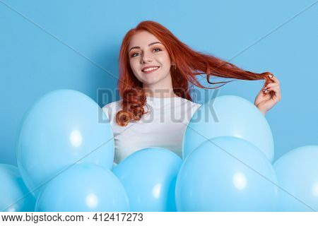 Lovely Ginger Female Flirts With Someone And Pulling Her Hair Aside, Wears White Shirt, Poses With I