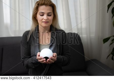 A Fortune Teller Gazes Into Her Ball