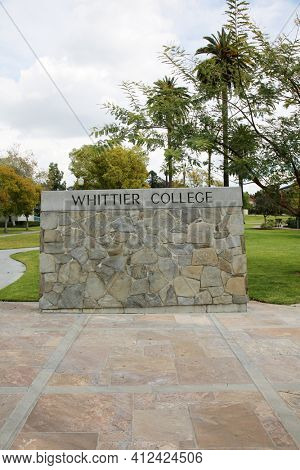 March 12, 2021 - Whittier, California: Whittier College. Large Rock Wall with WHITTIER COLLEGE Sign at the entrance to campus. Closed due to Coronavirus Pandemic. Editorial Use Only. 