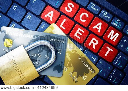 Scam Alert In Red Keys On High-tech Computer Keyboard Background With Security Engraved Lock On Fake