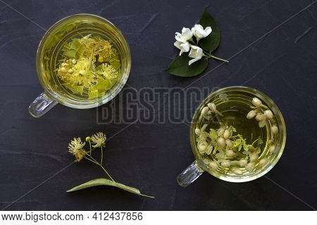 Jasmine Tea And Linden Flowers Tea.cups Of Hot Herbal Tea With Jasmine Fresh Flowers And Linden On A