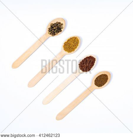 Seeds Of Beet, Arugula, Amaranth, Mustard In Wooden Spoons On A White Background. Place For An Inscr