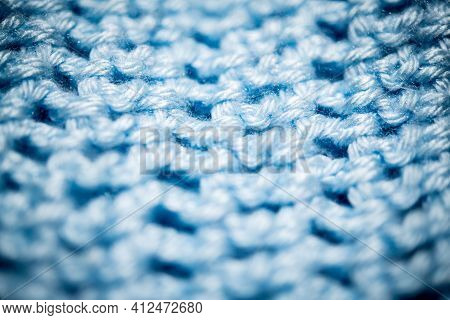 An Extreme Close-up Shot With Selective Focus Of A Piece Of Deep Blue Knitted Fabric.