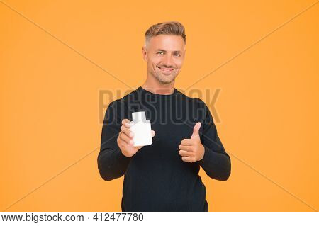 Happy Attractive Man In Casual Style Show Thumbs Ups Hand Gesture Holding Eau De Toilette Yellow Bac