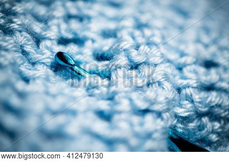 An Extreme Close-up Shot With Selective Focus Of A Piece Of Deep Blue Knitted Fabric With Blue Croch