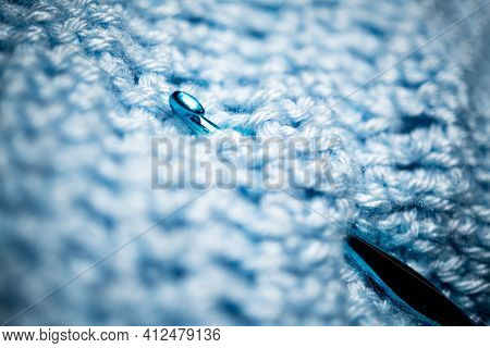 An Extreme Close-up Shot With Selective Focus Of A Piece Of Deep Blue Knitted Fabric With Blue Croch