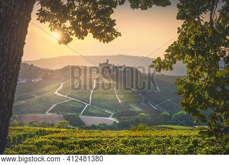 Langhe Vineyards, Castiglione Falletto Village And A Tree As A Frame At Sunset. Unesco Site, Piedmon