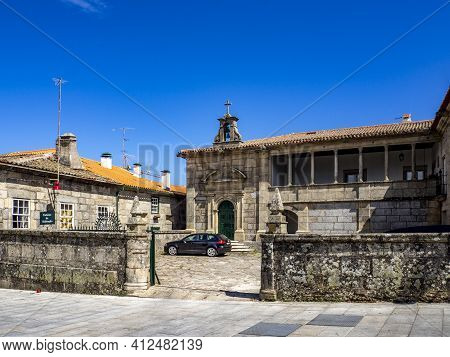 Guarda, Portugal; August 2020:  Old Stone Building With Walled Fence And Cobblestone Alley At Guarda