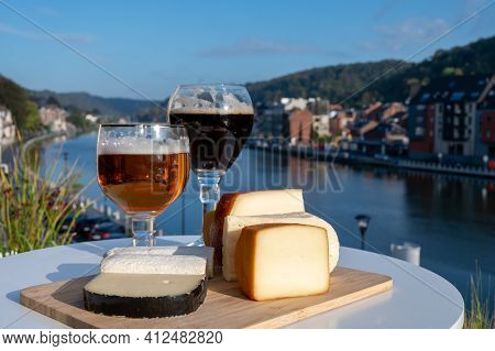 Glass Of Belgian Abbey Beer And Tasting Of Cheeses Made With Trappist Beer And Fine Herbs With View