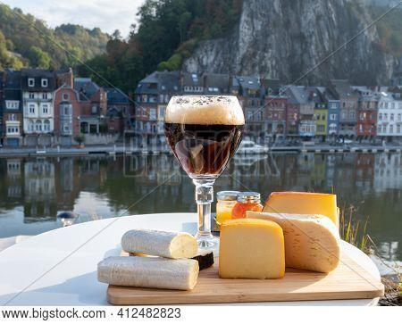 Glass Of Belgian Abbey Beer And Tasting Of Cheeses Made With Trappist Beer And Fine Herbs With View