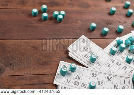 Many Barrels With Numbers And Cards For Lotto Or Russian Bingo Table Game On Wooden Surface. Russian