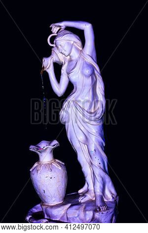 Fountain Statue Of A Young Lady Fetching Water With Small Pot And Pouring Into A Large Water Jar