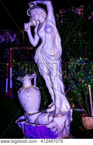 Fountain Statue Of A Young Lady Fetching Water With Small Pot And Pouring Into A Large Water Jar