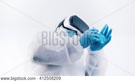African American Black Doctor In Protective Uniform And With Vr Glasses Putting On Gloves. High Qual