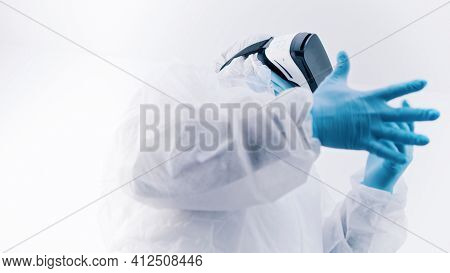 African American Black Doctor In Protective Uniform And With Vr Glasses Putting On Gloves. High Qual
