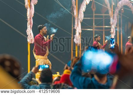 17.12.2019, Varanasi, India. Sacred Religious Ceremony Arati In The Temple. A Group Of People Burn I