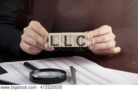 Businesswoman Holding Wooden Block With Text Llc , Business