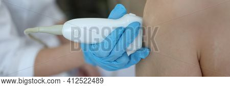 Doctor Doing Ultrasound Examination Of Knee Joint Closeup