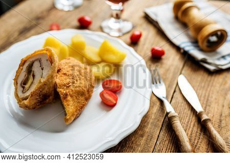 Traditional French Cuisine Chicken Roll Cordon Bleu Or Gordon Blue With Cheese, Ham And Potatoes