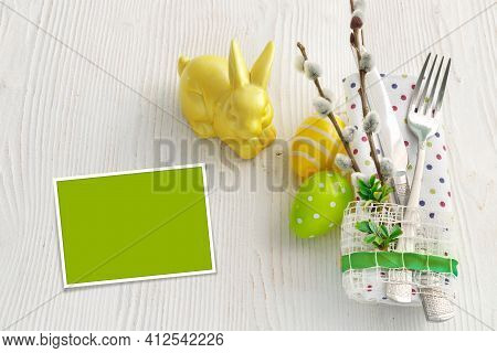 Sweet Easter Symbols Colored Yellow And Green Eggs On White Wooden Table.
Spring Table Setting With 