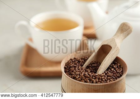 Bowl With Buckwheat Tea Granules And Wooden Scoop On Table, Closeup. Space For Text