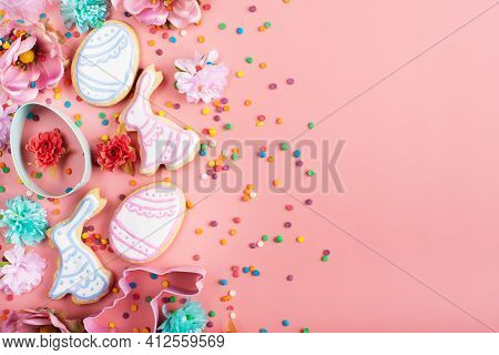 Sugar Sprinkles, Cookie Cutters, Easter Frosted Cookies In Shape Of Egg And Rabbit On Pink Backgroun