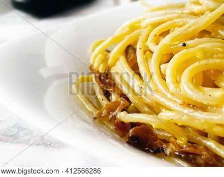Detail Of Spaghetti Carbonara Served In A White Dish. Italian Food. Famous Typical Roman Recipe. Clo