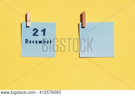 21 December. 21th Day Of The Month, Calendar Date. Two Blue Sheets For Writing On A Yellow Backgroun
