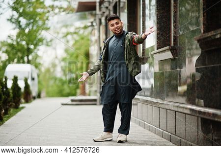 Сonfident Pakistani Indian Muslim Arabic Boy In Grey Kameez Shalwar Suit.