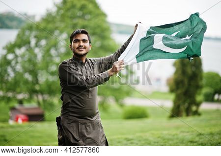 Indo Pakistani Man Wear Traditional Clothes Achkan Or Sherwani With Pakistan Flag.