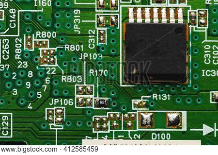 Green Electronic Board With Radioelements Close-up. Background For The Theme Of Electronics And High