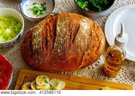 Continental, healthy breakfast containing homemade bread, vegetables tomatoes, argula, salad and olive