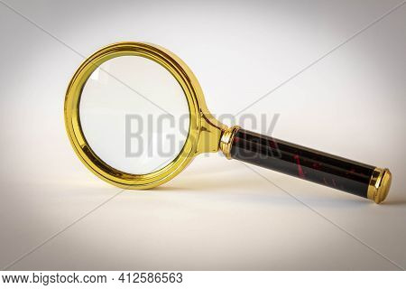 Magnifying Glass On A Light Background. The Concept Of Information Search. Selective Focus