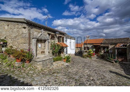 Belmonte, Portugal; May 2017 : Deserted Alley And Charming Old Small House With Stone Niche For Sain