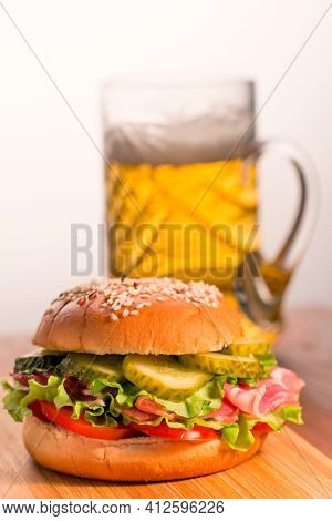 Hamburger On The Background Of A Beer Mug.