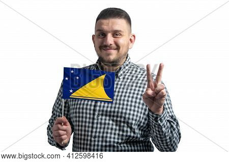 White Guy Holding A Flag Of Tokelau And Shows Two Fingers Isolated On A White Background.