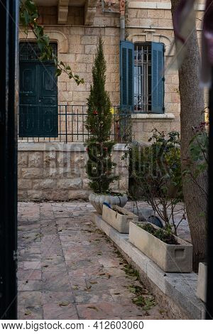 Evening View Of A Decorated Christmas Tree Near A House On Hovevei Tsiyon Street In The Old Jerusale