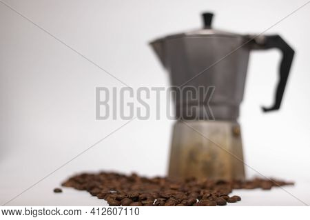 Geyser Coffee Maker Or Moka Pot Isolated On White Background With Coffee Beans Nearby.