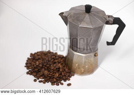 Geyser Coffee Maker Or Moka Pot Isolated On White Background With Coffee Beans Nearby.