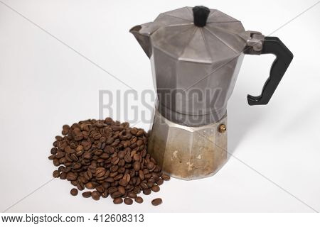 Geyser Coffee Maker Or Moka Pot Isolated On White Background With Coffee Beans Nearby.