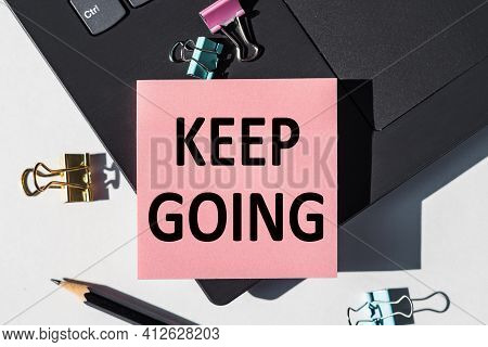 Keep Goin Note Is Written On A Paper Sticker On A Laptop Keyboard.