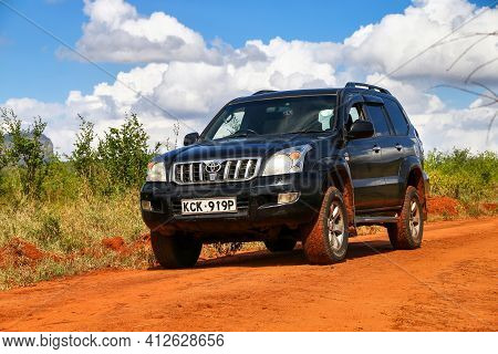 Taita Hills, Kenya - February 3, 2021: Black Offroad Car Toyota Land Cruiser Prado 120 At The Red Cl
