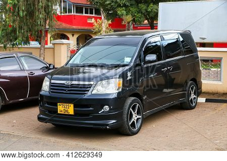 Arusha, Tanzania - February 6, 2021: Black Minivan Toyota Noah R60 In The City Street.