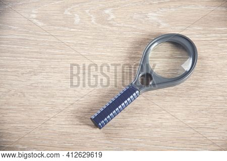 Magnifying Glass With The Wooden Table Bakcground