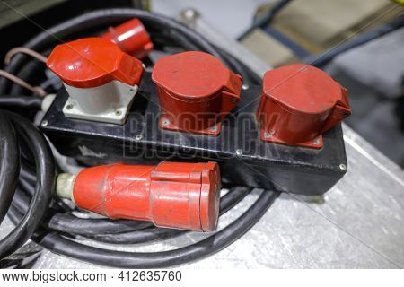 Shallow Depth Of Field (selective Focus) Image With Industrial And Multiphase Electrical Plugs And S