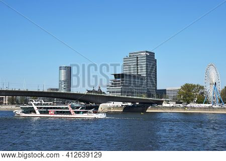 Pleasure Boat Sailing On The Rhine, The Deutzer Brucke And The Lanxess Tower, The Headquarters Of La