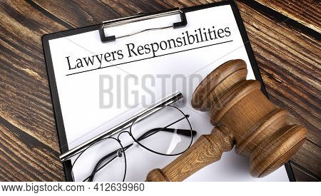 Paper With Lawyers Responsibilities With Gavel, Pen And Glasses On Wooden Background