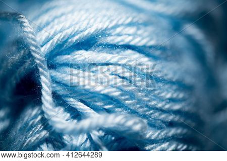 An Extreme Close-up With Selective Focus Of Blue And Fuzzy Bundled Crochet Threads.